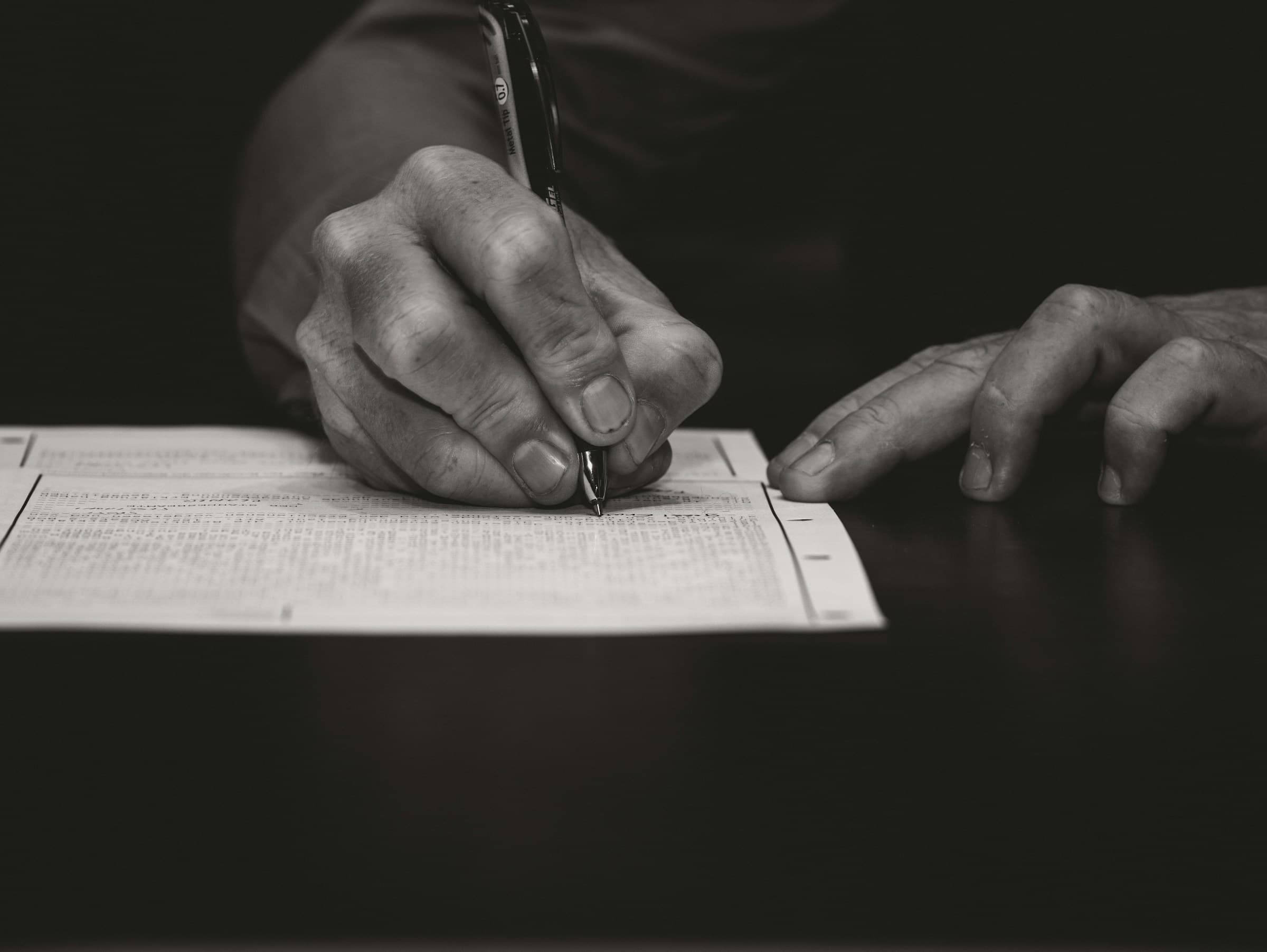 A hand writing with a fountain pen on paper